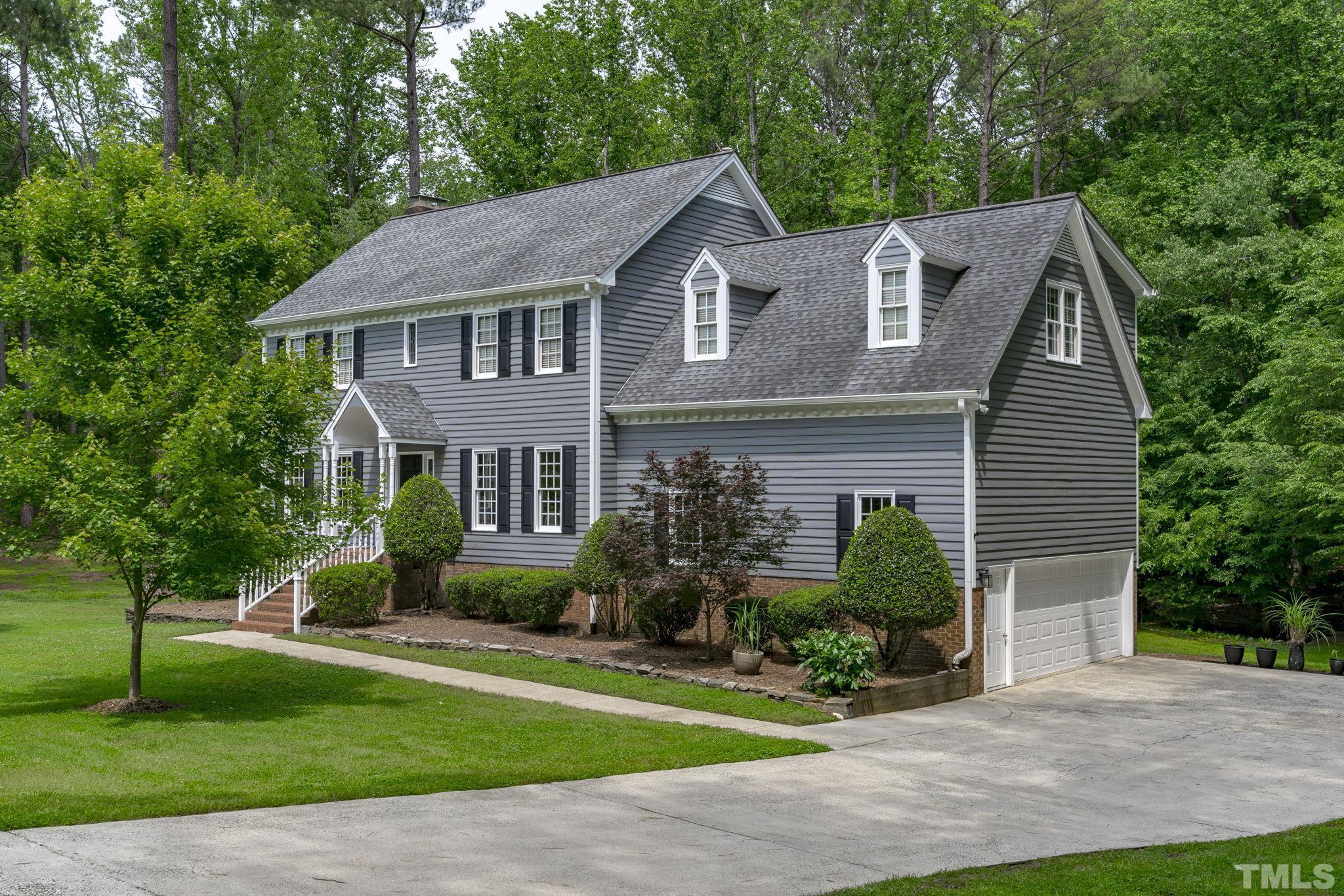 2821 Patrie Place Raleigh, NC 27613 - Photo 7 of 62 a front view of a house with a garden