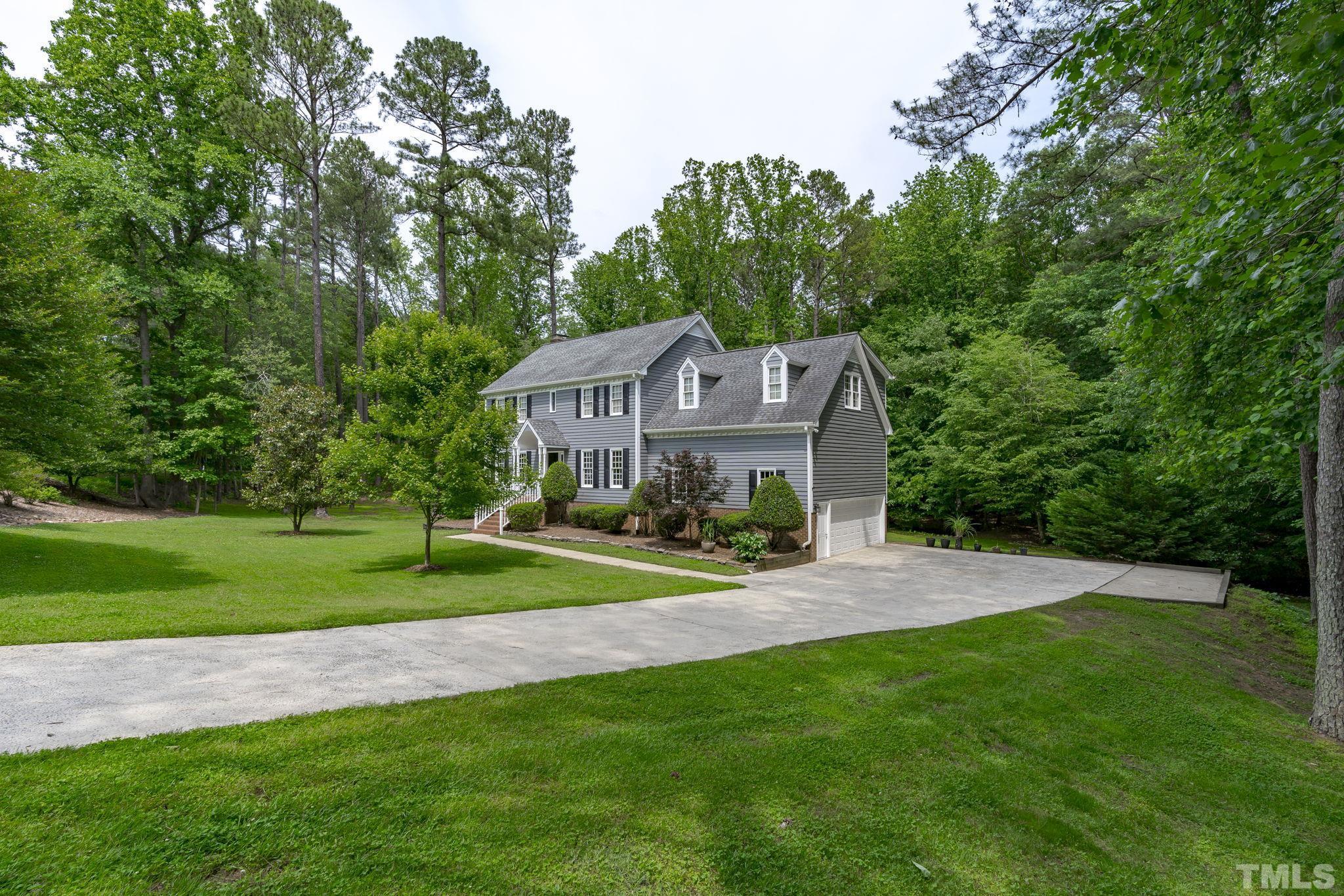 2821 Patrie Place Raleigh, NC 27613 - Photo 9 of 62 a view of a big house with a big yard and large trees