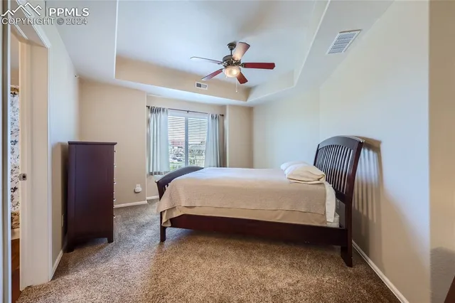 a bedroom with a bed and a mirror