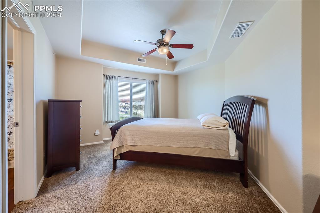 3790 Presidio Point, Unit 201 Colorado Springs, CO 80920 - Photo 4 of 11 a bedroom with a bed and a mirror
