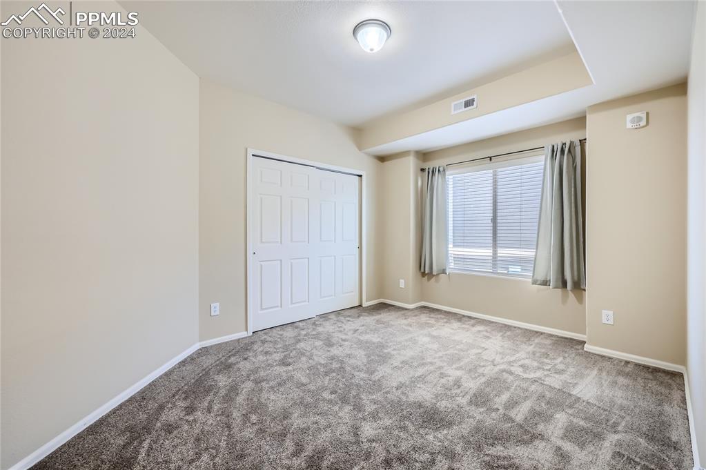 3790 Presidio Point, Unit 201 Colorado Springs, CO 80920 - Photo 8 of 11 an empty room with windows and closet