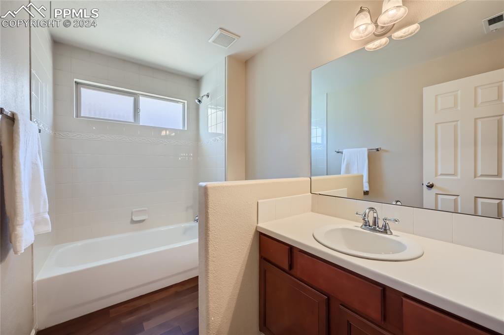 3790 Presidio Point, Unit 201 Colorado Springs, CO 80920 - Photo 9 of 11 a bathroom with a sink double vanity granite tub and a mirror