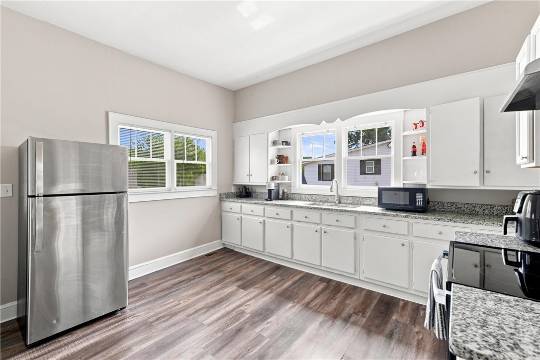 7 McCaughrin Street Pelzer, SC 29669 - Photo 19 of 24 A kitchen features modern appliances, ample counter space, and durable flooring for everyday living.