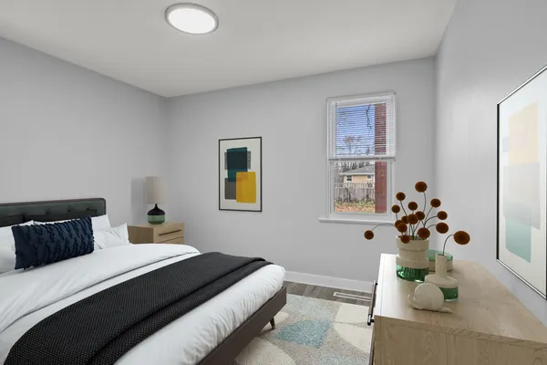 a bedroom with a bed and a potted plant
