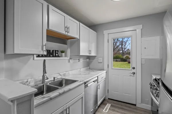 a kitchen with a sink cabinets and window