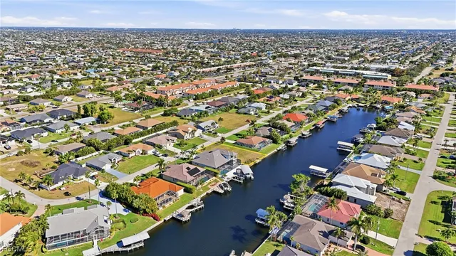 an aerial view of residential houses with outdoor space and lake view