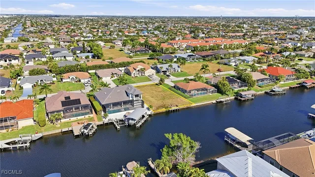 an aerial view of residential houses with outdoor space and river