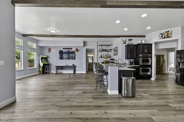 a living room with furniture fireplace and wooden floor