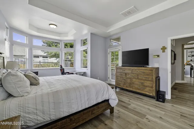 a bedroom with a bed and flat screen tv