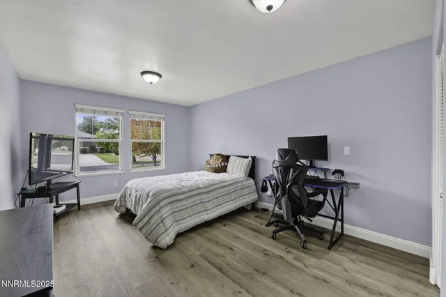 a view of a workspace with furniture and wooden floor