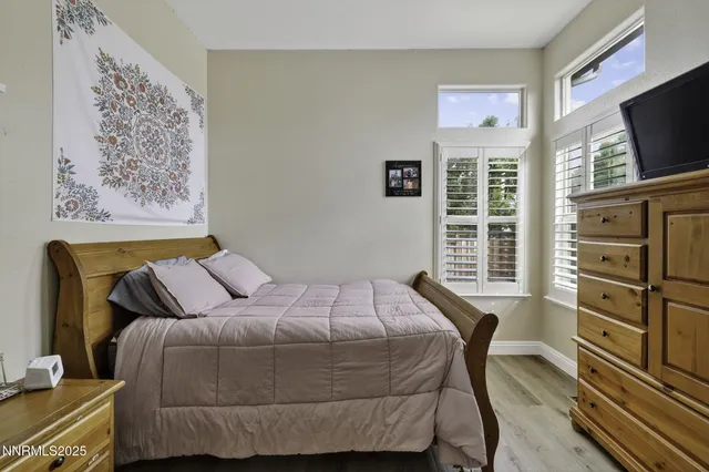 an aerial view of green landscape with trees houses and lake view