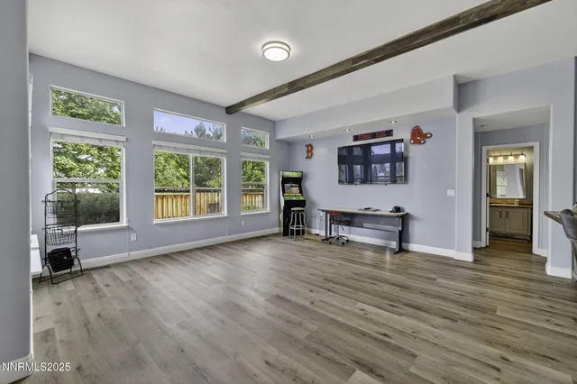 a view of a room with furniture and wooden floor