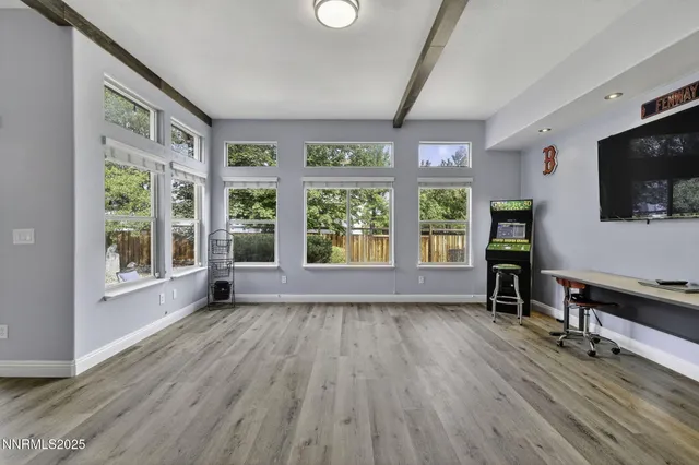 a living room with stainless steel appliances kitchen island granite countertop furniture and wooden floor
