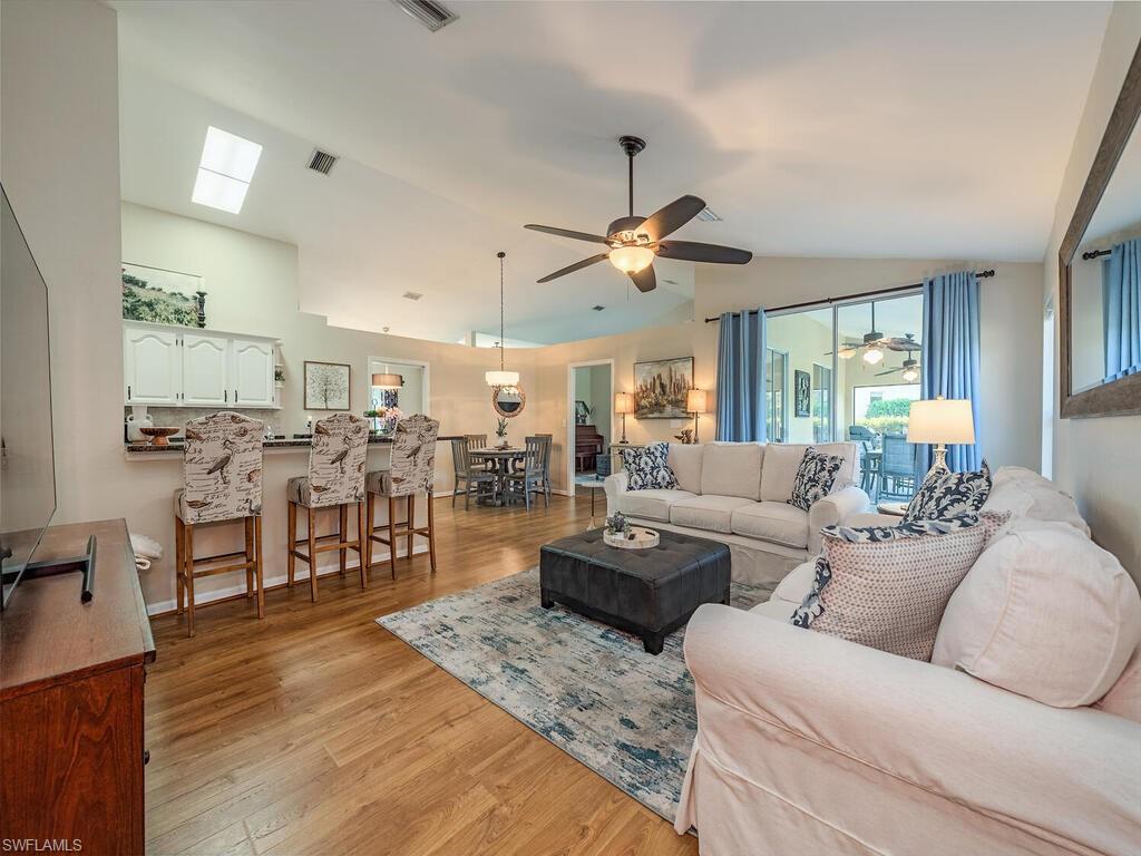 579 Raven Way Naples, FL 34110 - Photo 1 of 19 a living room with furniture kitchen view and a large window
