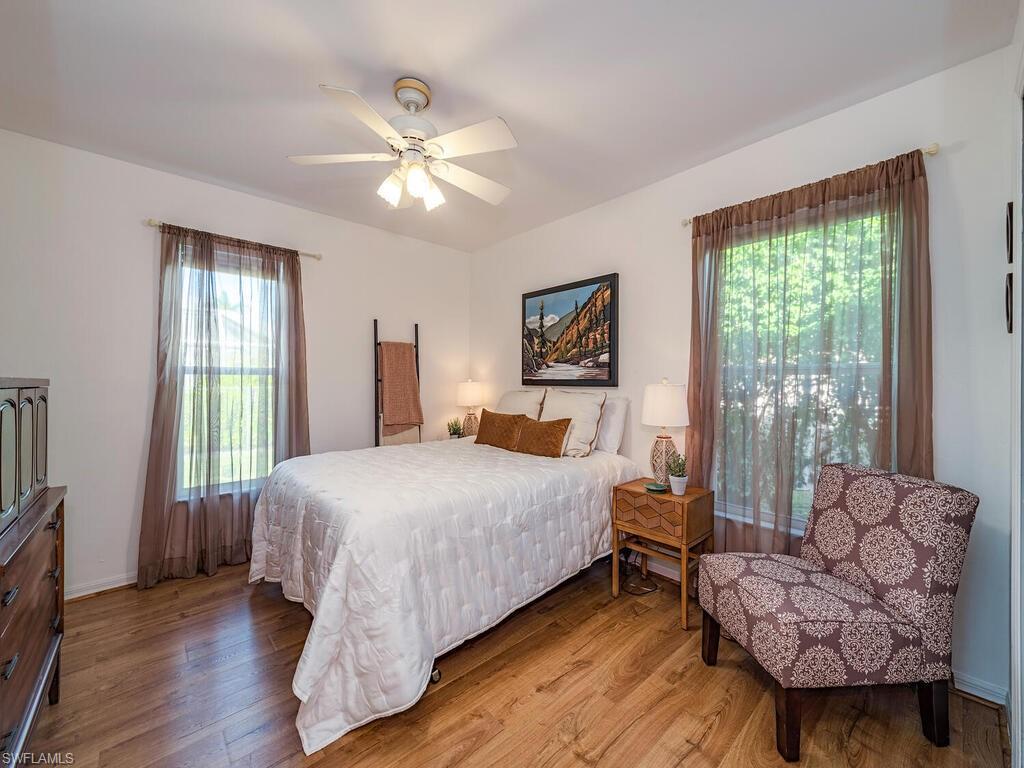 579 Raven Way Naples, FL 34110 - Photo 12 of 19 a bedroom with a bed and a couch