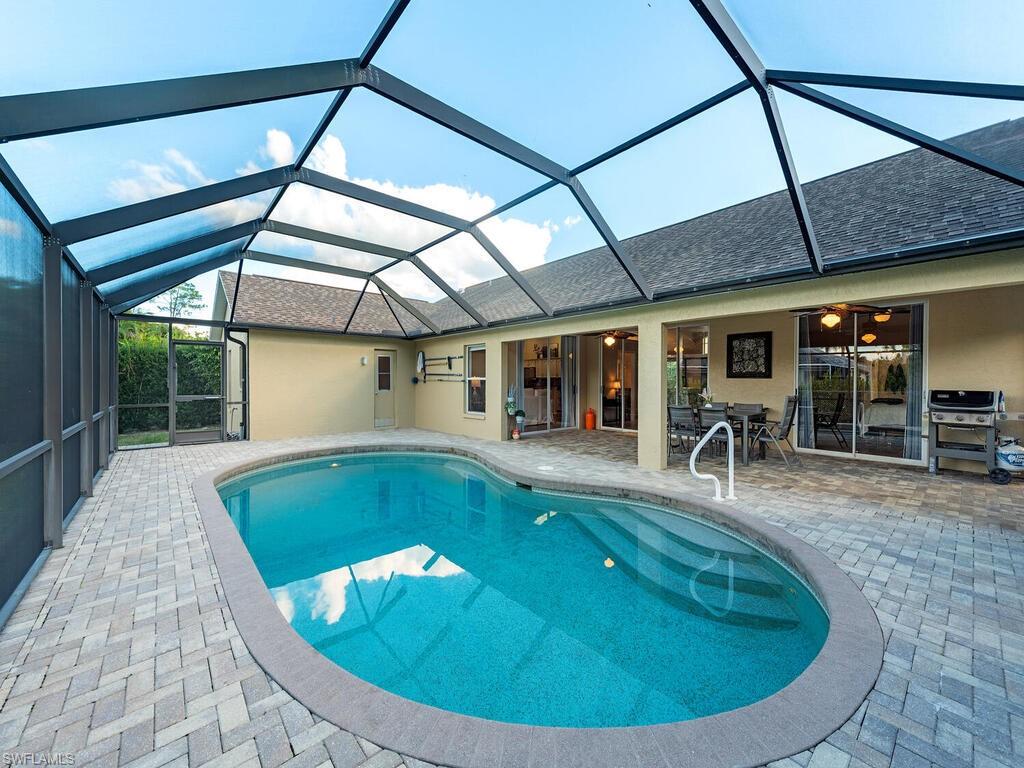 579 Raven Way Naples, FL 34110 - Photo 17 of 19 a view of a swimming pool with a patio