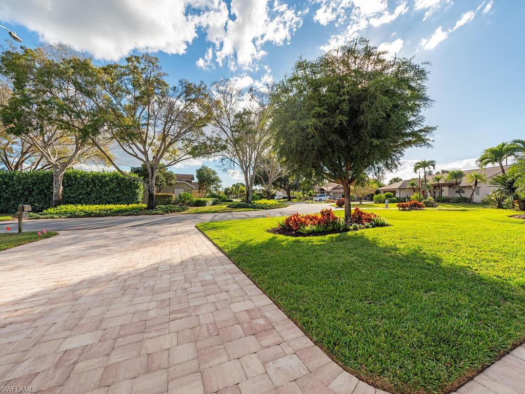 579 Raven Way Naples, FL 34110 - Photo 19 of 19 a view of a fountain in front of a house with a big yard