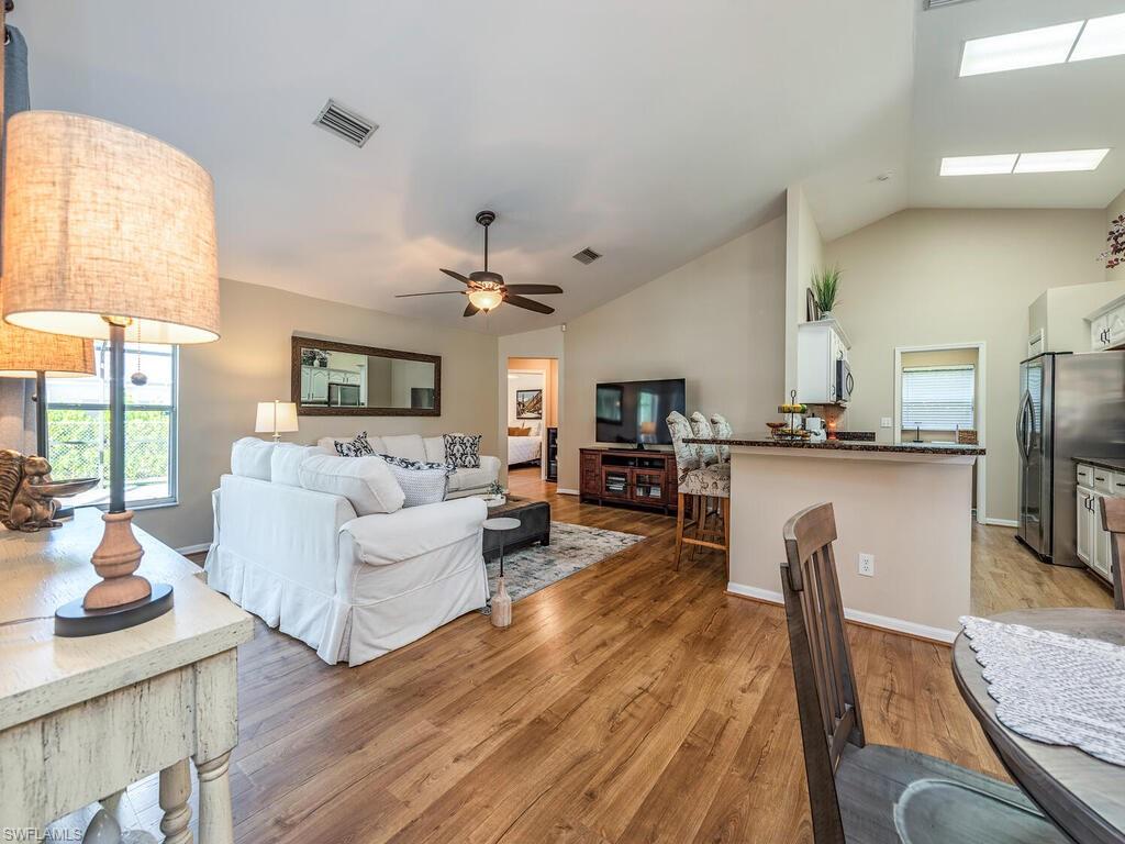 579 Raven Way Naples, FL 34110 - Photo 2 of 19 a living room with fireplace furniture and a flat screen tv
