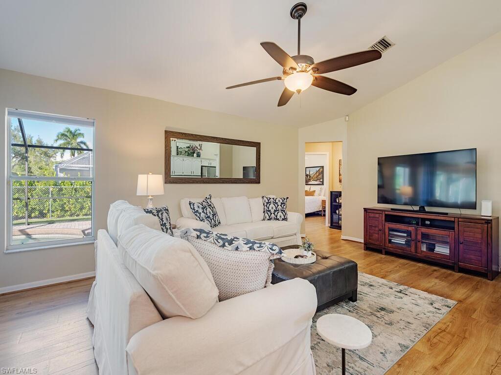 579 Raven Way Naples, FL 34110 - Photo 3 of 19 a living room with furniture and a flat screen tv