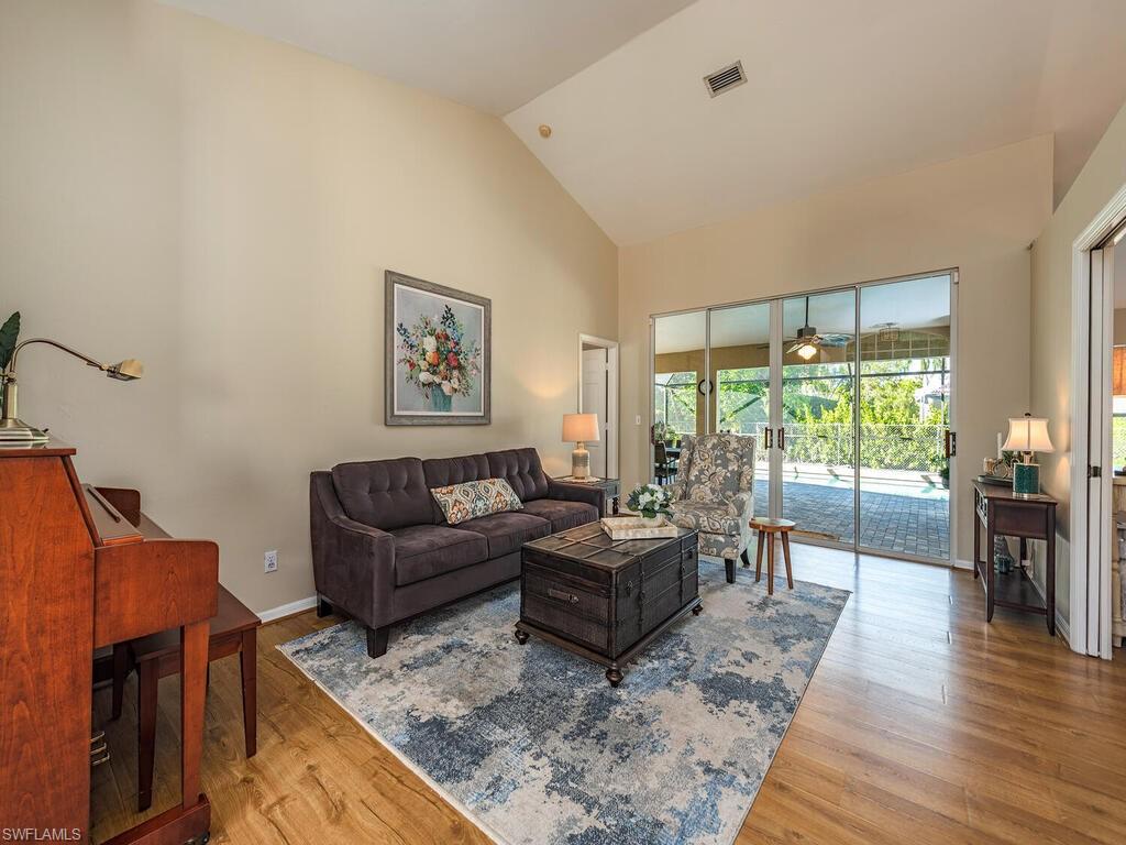 579 Raven Way Naples, FL 34110 - Photo 7 of 19 a living room with furniture and a large window