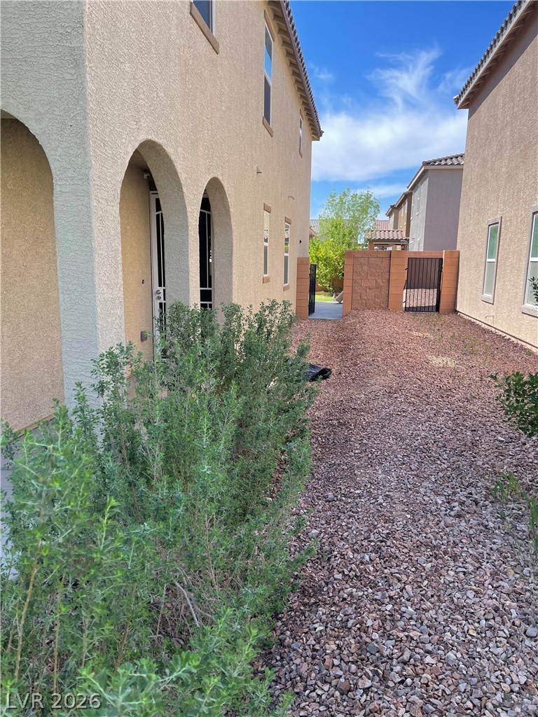 9325 Keystone Ridge Avenue Las Vegas, NV 89148 - Photo 13 of 17 Arched entryways and xeriscape landscaping define this desert-inspired residence.