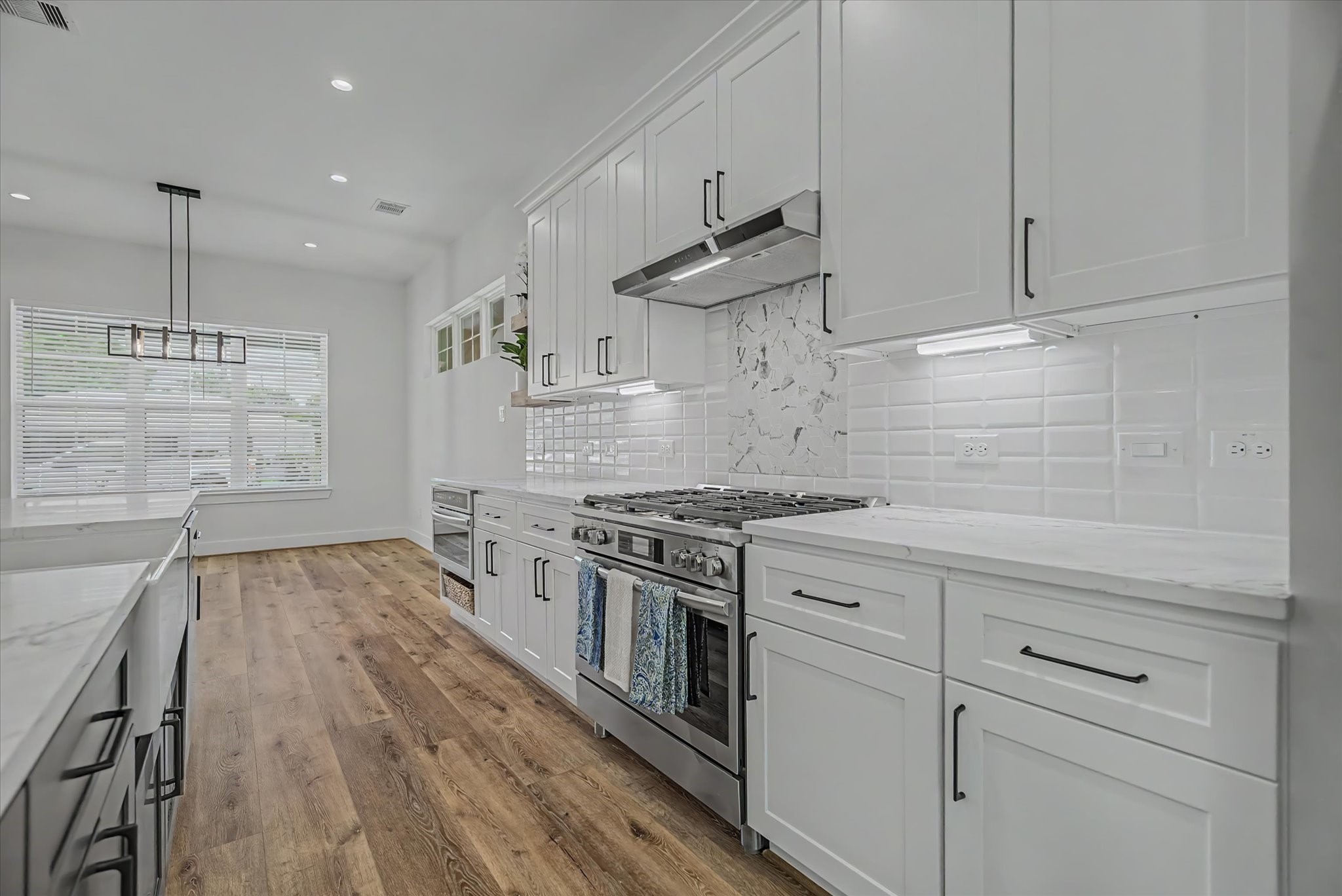 3806 Dreyfus Street Houston, TX 77021 - Photo 13 of 48 Custom kitchen featuring soft-close cabinetry, drawers, and integrated under-cabinet lighting.