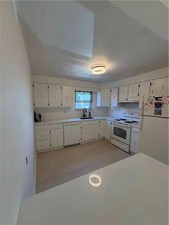 a bathroom with a toilet a sink and a shower