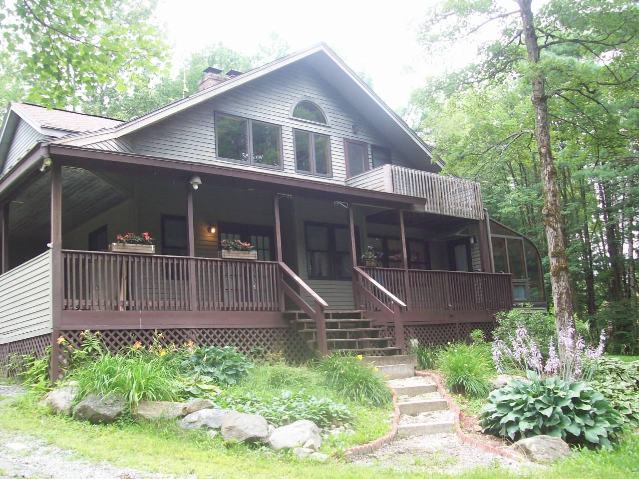 496 Dimmock Road Otis, MA 01253 - Photo 1 of 22 a front view of a house with a yard