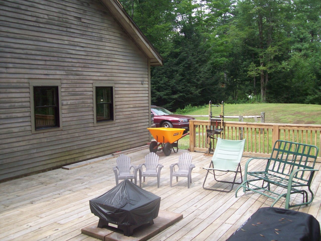 496 Dimmock Road Otis, MA 01253 - Photo 5 of 22 a view of a chairs and table on the wooden deck