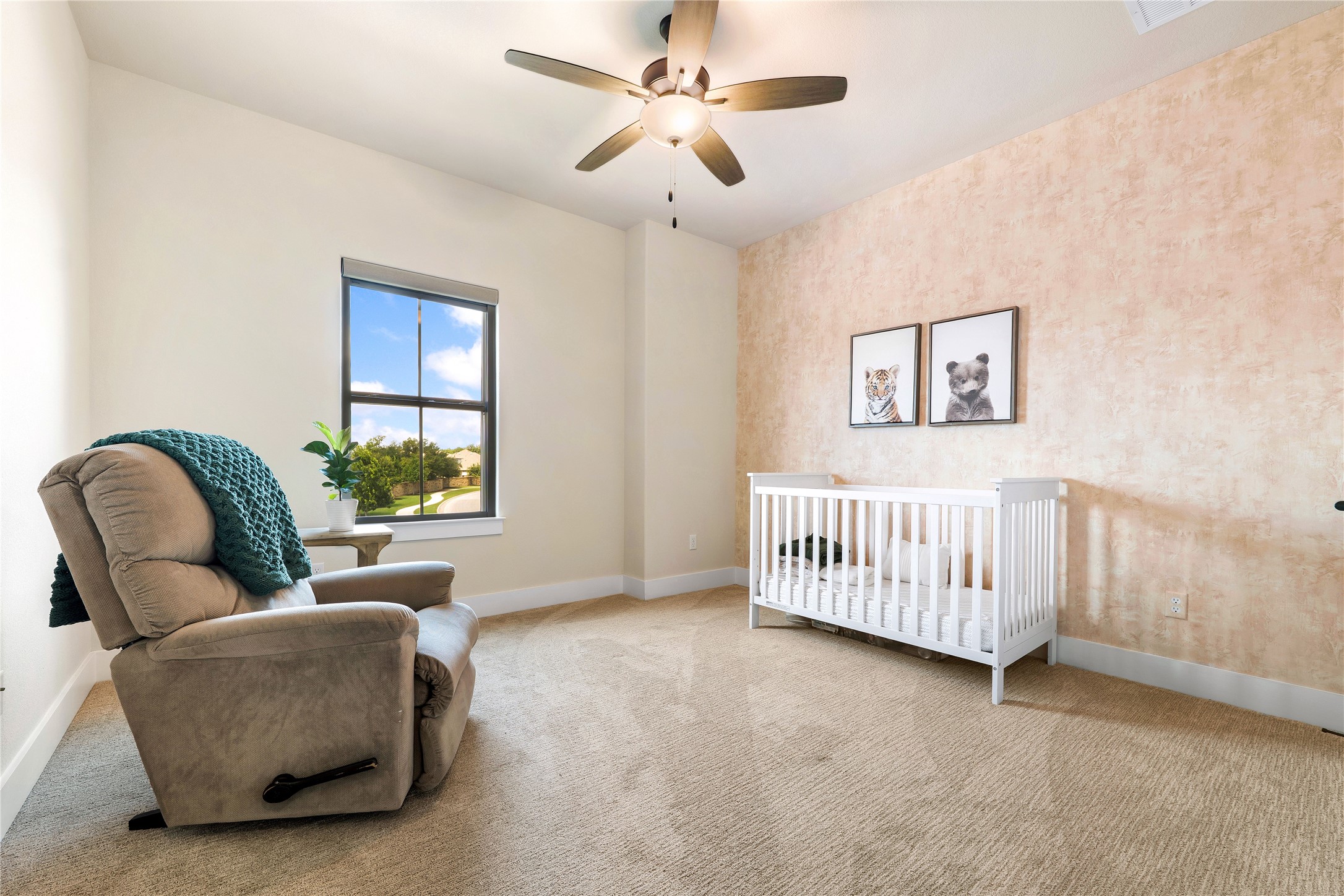 2408 Nate's Place Georgetown, TX 78633 - Photo 29 of 40 A well-lit bedroom features a window overlooking the neighborhood and a ceiling fan for comfort.
