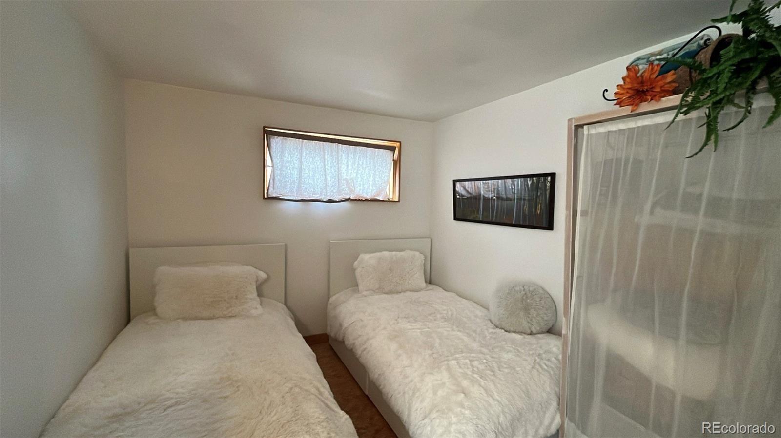 847 Airport Road Breckenridge, CO 80424 - Photo 13 of 24 a bedroom with a bed and a painting on the wall