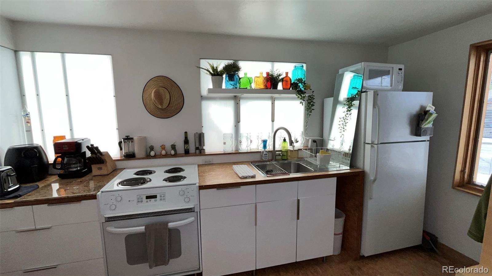 847 Airport Road Breckenridge, CO 80424 - Photo 5 of 24 a kitchen with stainless steel appliances granite countertop a sink stove and refrigerator
