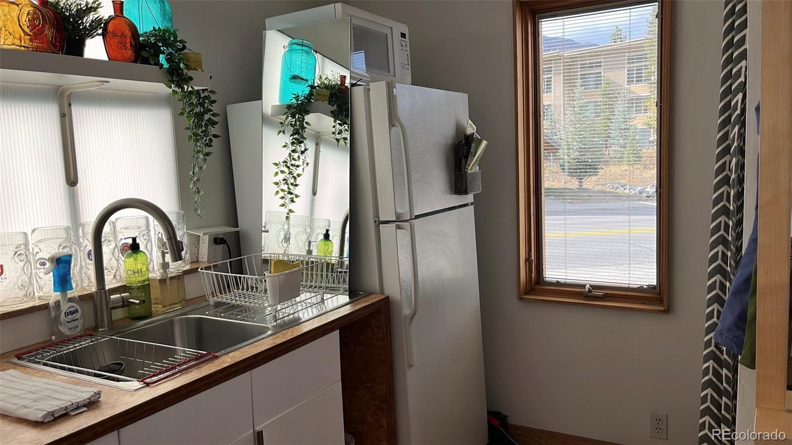 847 Airport Road Breckenridge, CO 80424 - Photo 6 of 24 a kitchen with a refrigerator and a sink