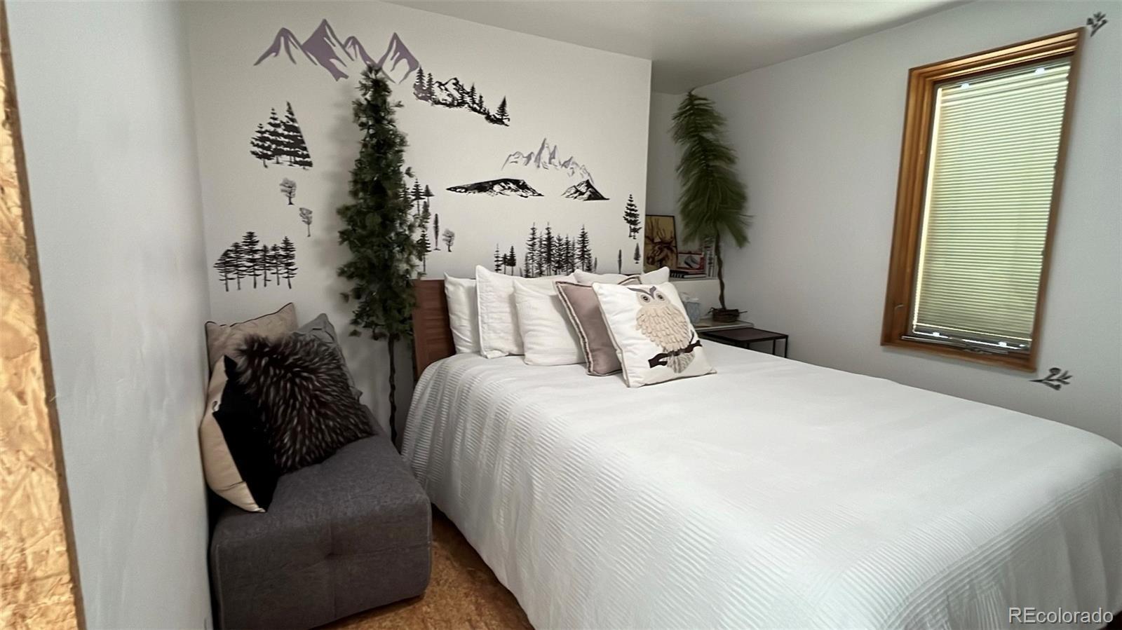 847 Airport Road Breckenridge, CO 80424 - Photo 8 of 24 a bedroom with a bed and a painting on the wall