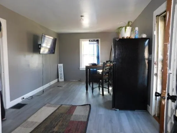 a view of a livingroom with furniture wooden floor and a window