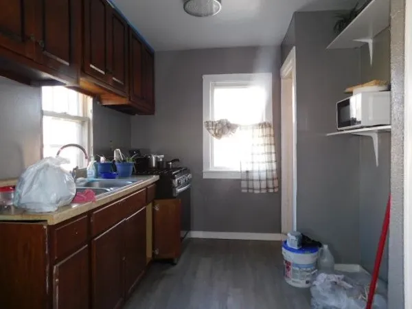 a kitchen with stainless steel appliances granite countertop a refrigerator and a sink
