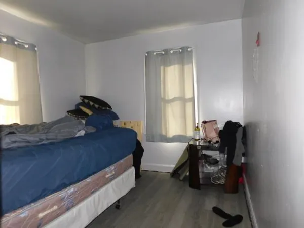 a bedroom with a bed and a chair