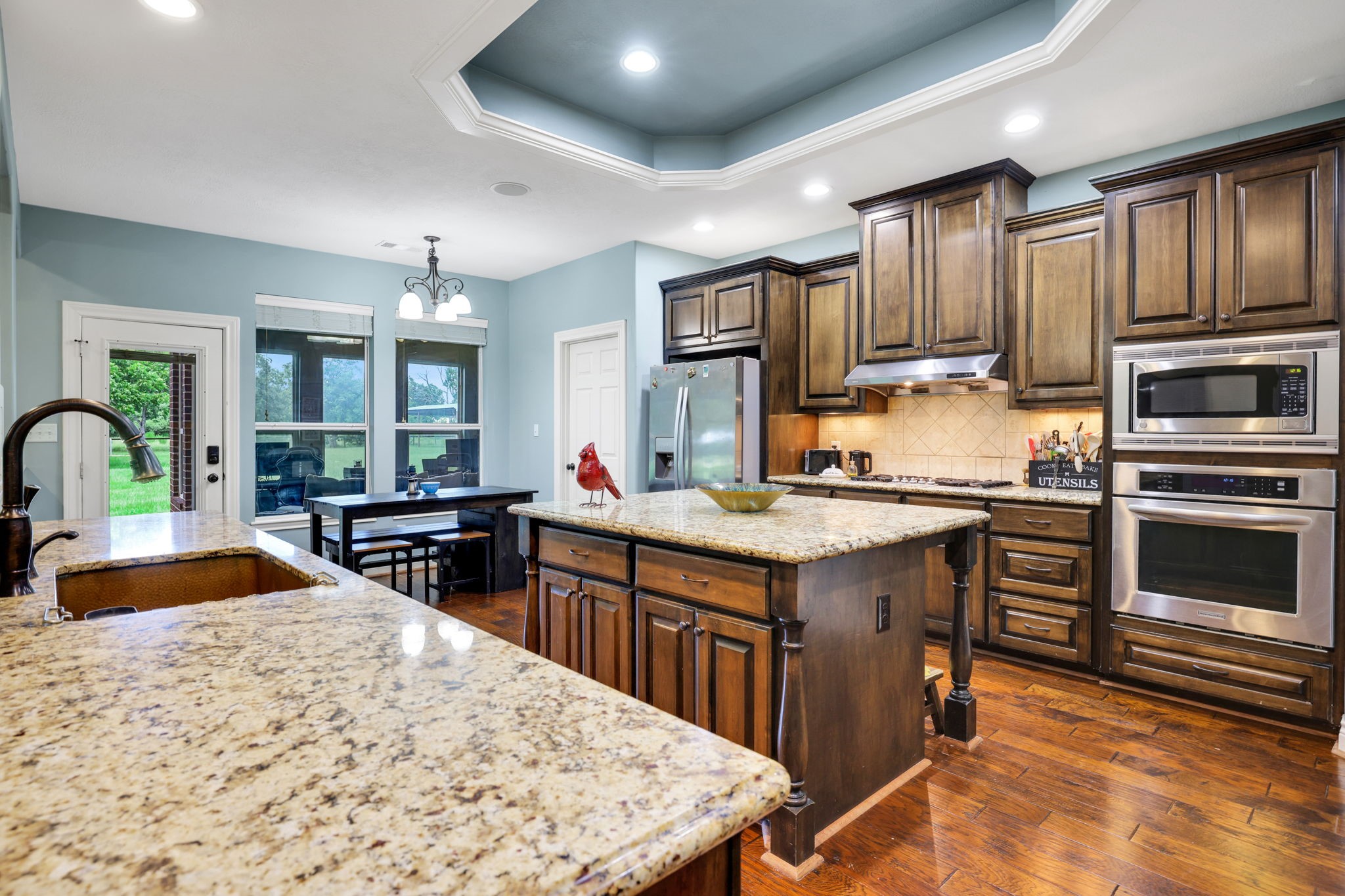 19407 Pine Tree Lane Waller, TX 77484 - Photo 20 of 39 a kitchen with granite countertop a stove refrigerator and cabinets