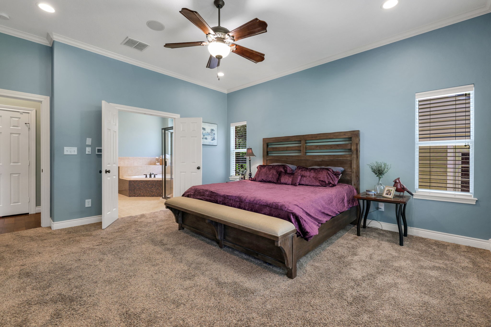19407 Pine Tree Lane Waller, TX 77484 - Photo 22 of 39 a spacious bedroom with a bed and a chandelier