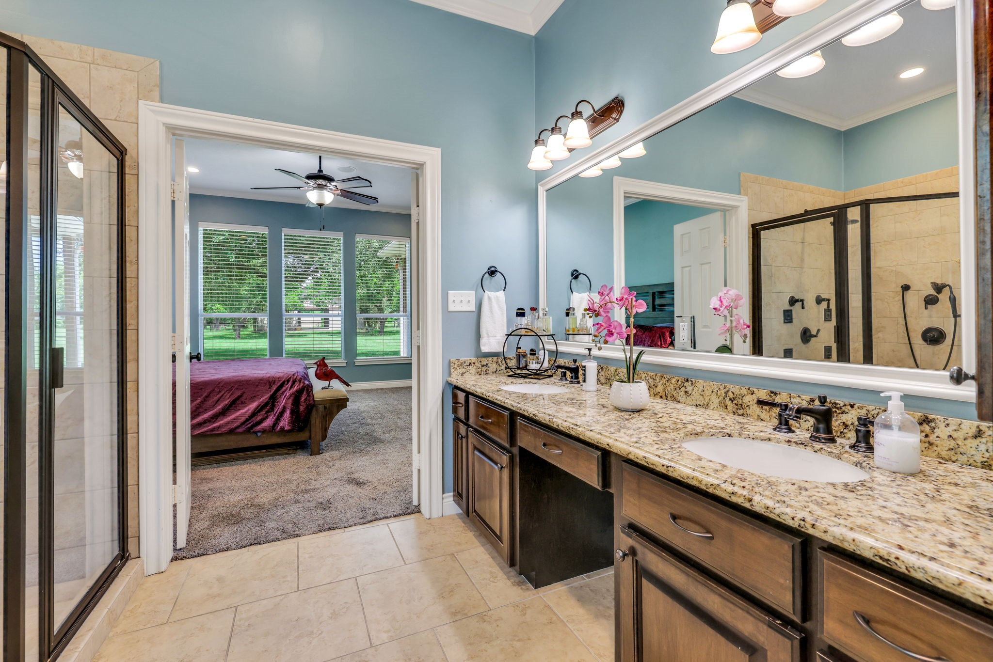 19407 Pine Tree Lane Waller, TX 77484 - Photo 23 of 39 a en suite bathroom with a granite countertop sink and a large mirror