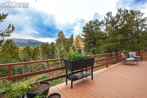 a view of a roof deck with wooden floor and fence