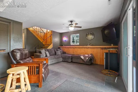 a view of a patio with table and chairs with wooden fence and plants