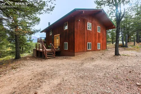 a view of outdoor space with garden and trees