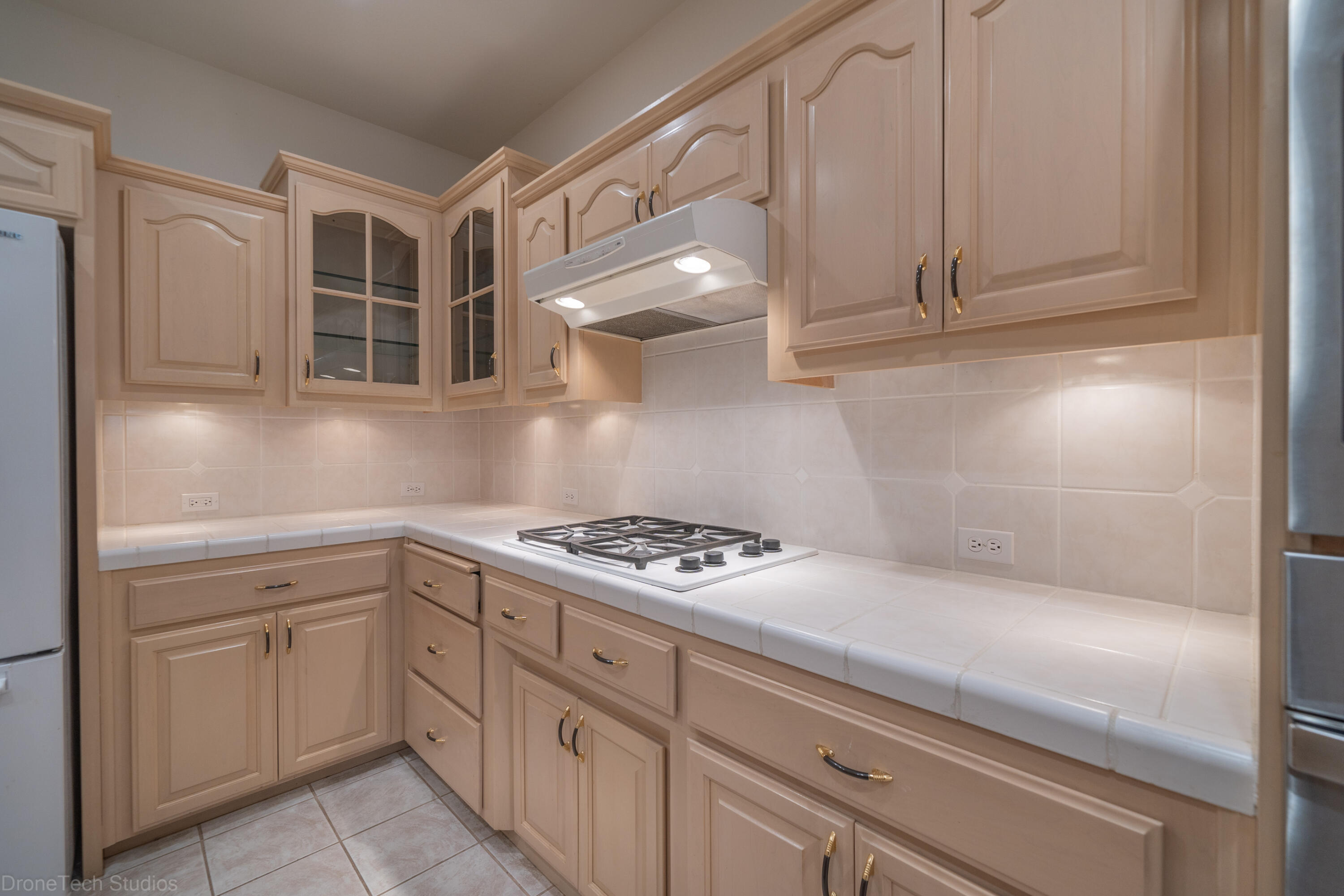 833 Cherryhill Trail Redding, CA 96003 - Photo 11 of 42 a kitchen with white cabinets and appliances