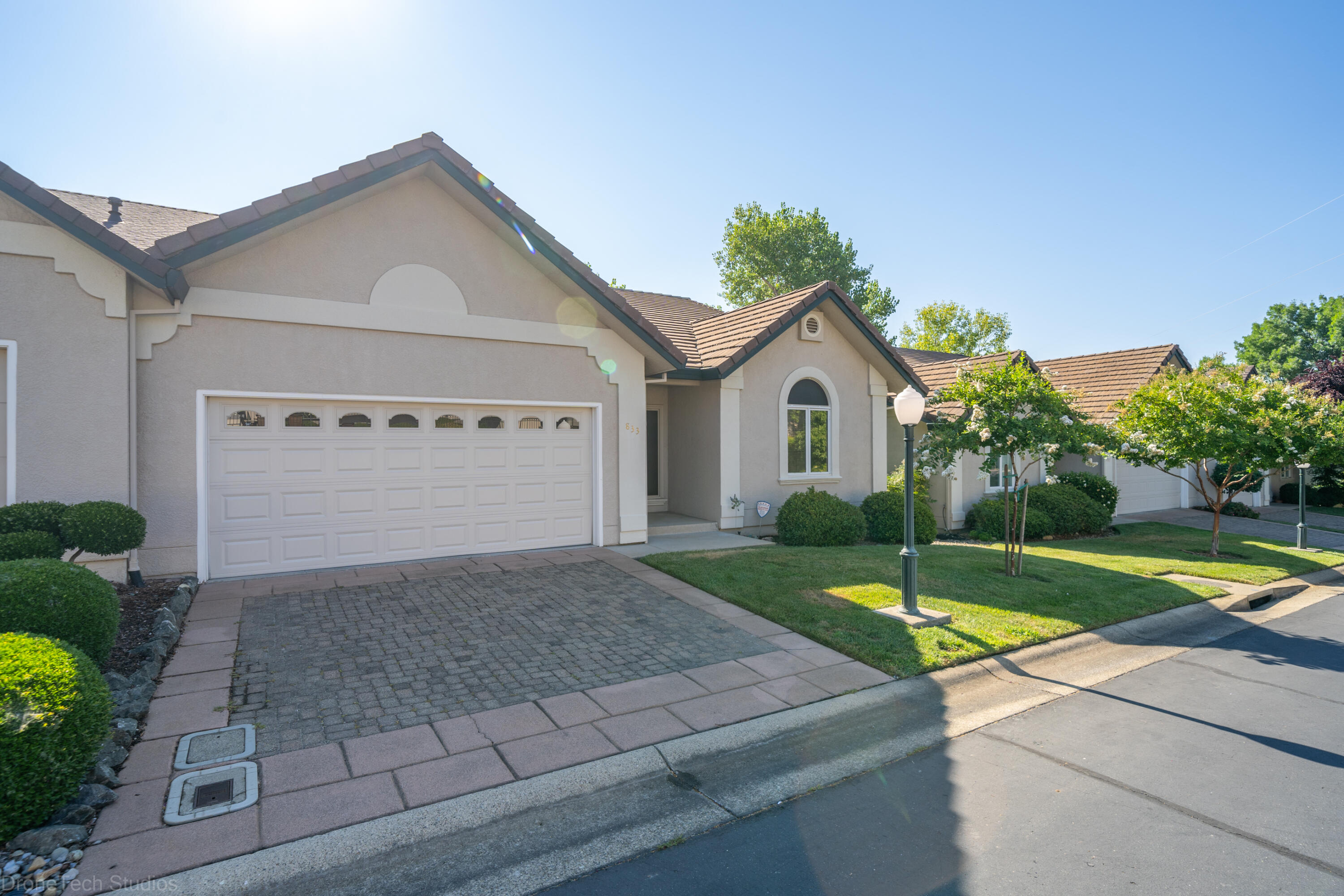 833 Cherryhill Trail Redding, CA 96003 - Photo 2 of 42 a front view of a house with a yard and garage