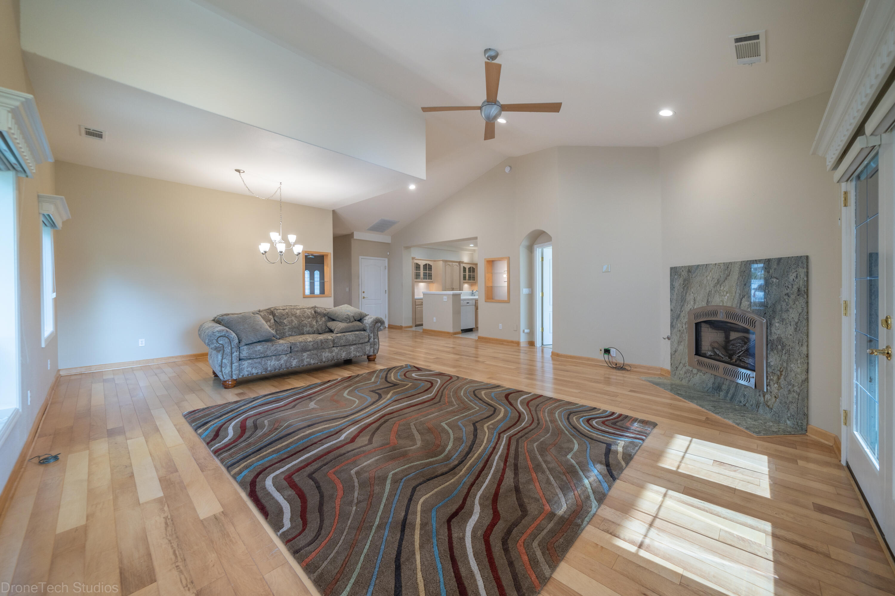 833 Cherryhill Trail Redding, CA 96003 - Photo 6 of 42 a spacious bedroom with a bed a ceiling fan and a rug