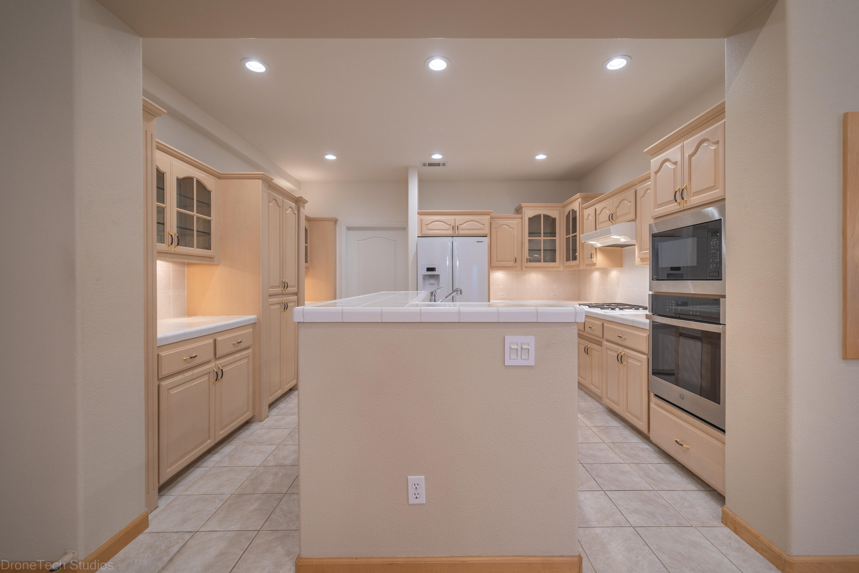 833 Cherryhill Trail Redding, CA 96003 - Photo 8 of 42 a kitchen with white cabinets and stainless steel appliances
