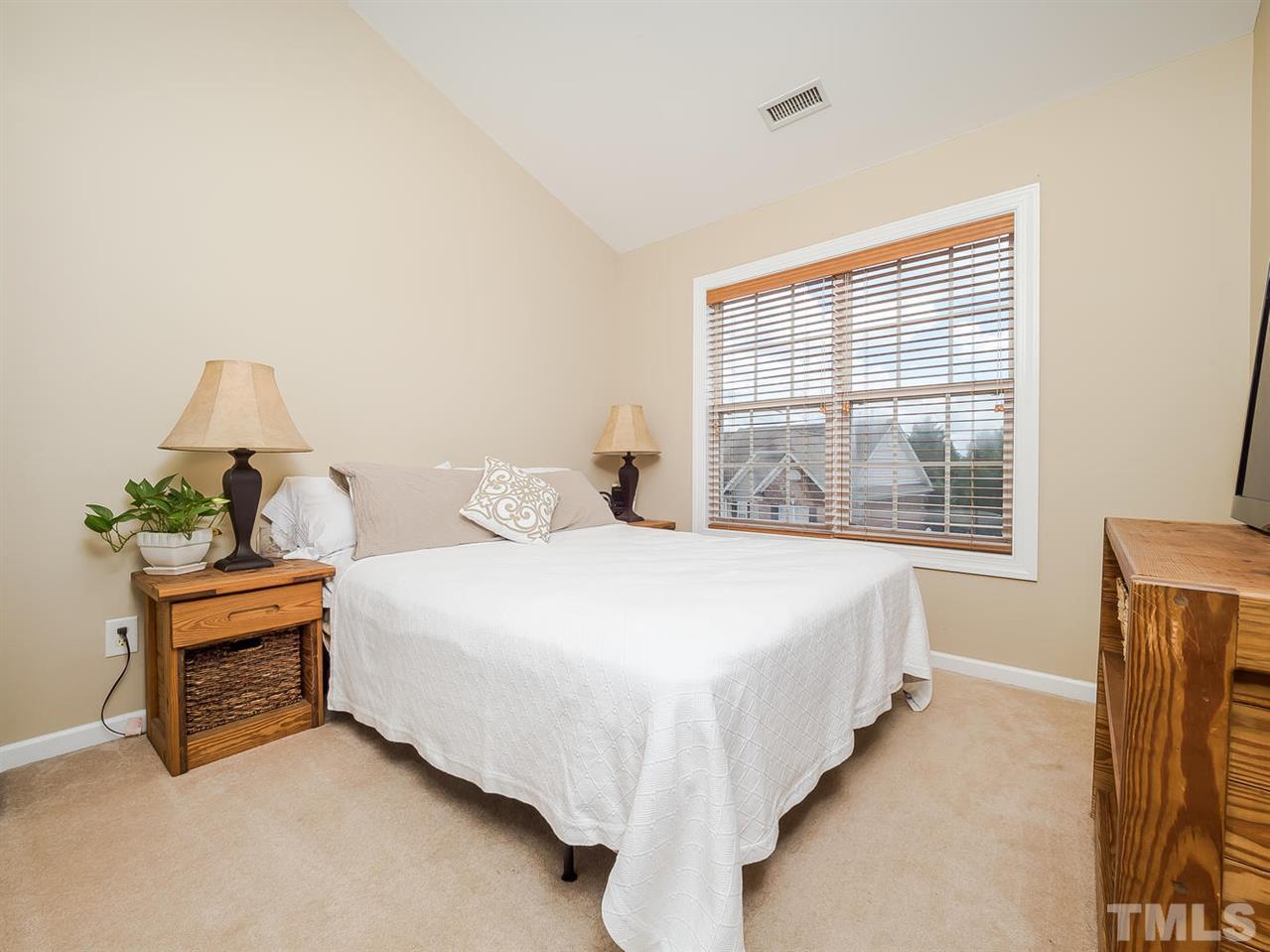 3005 Imperial Oaks Drive Raleigh, NC 27614 - Photo 12 of 25 a large bed sitting in a bedroom next to a window