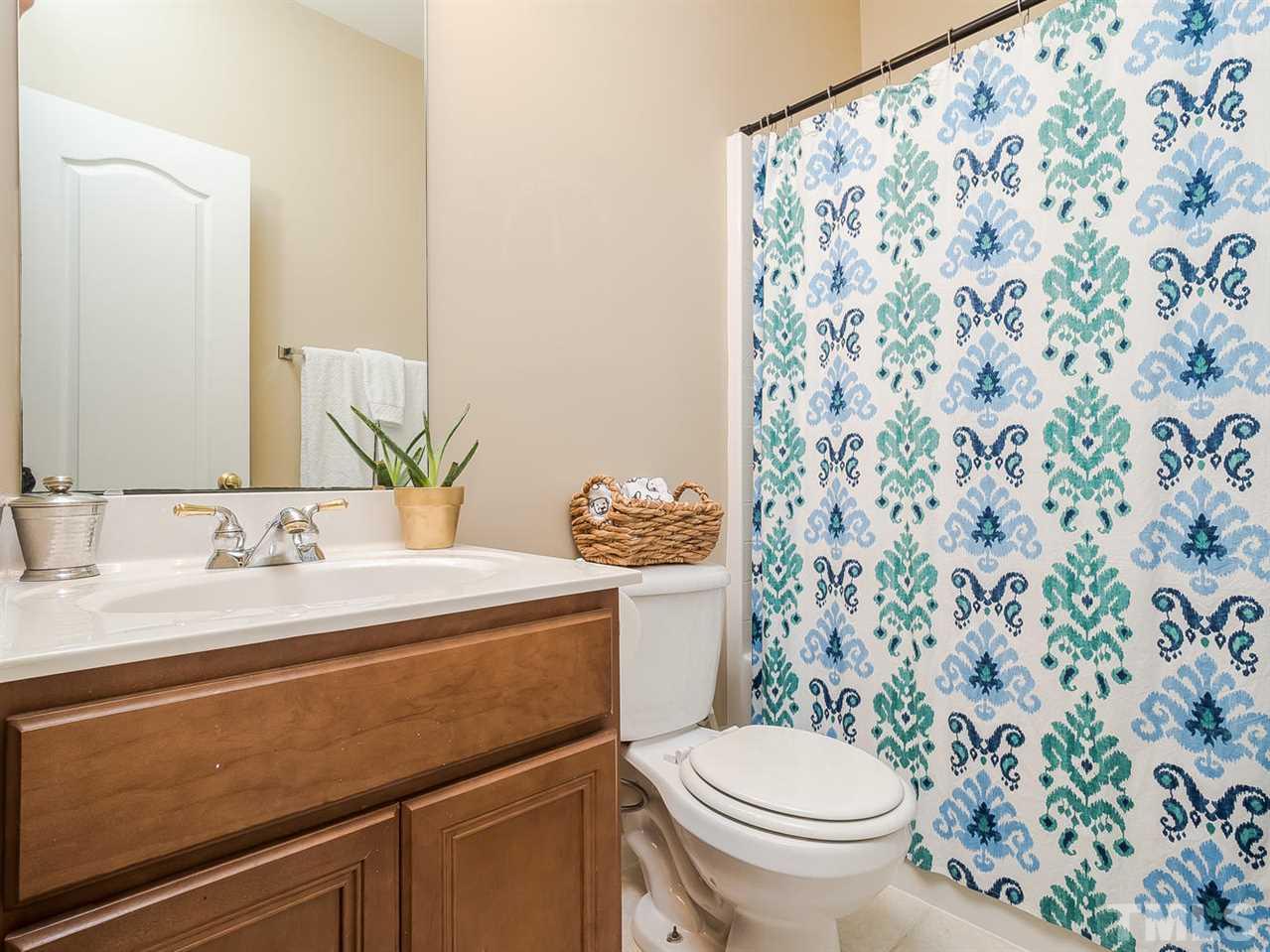 3005 Imperial Oaks Drive Raleigh, NC 27614 - Photo 14 of 25 a bathroom with a granite countertop sink a toilet and a mirror