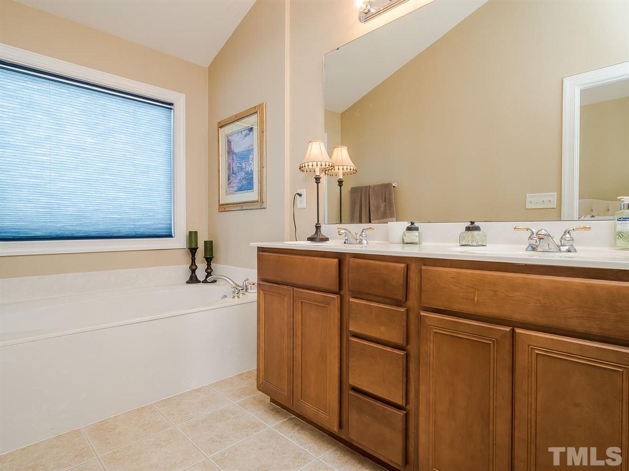 3005 Imperial Oaks Drive Raleigh, NC 27614 - Photo 16 of 25 a bathroom with a sink and a mirror